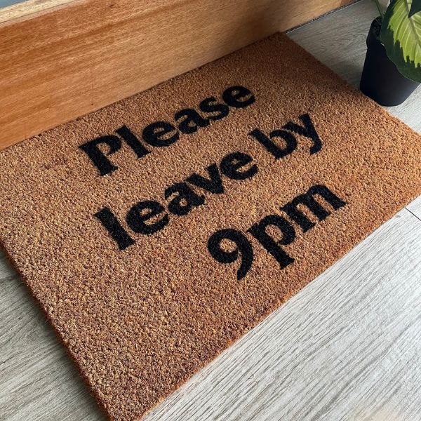 Doormat that says 'Please leave by 9pm'